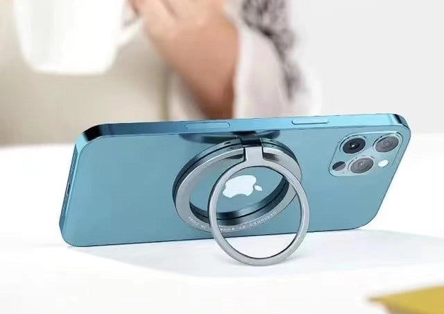 An iPhone standing in landscape on a table, propped on the grey ring